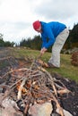 Hiking man try to light fire Royalty Free Stock Photo