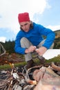 Hiking man try to light fire Royalty Free Stock Photo