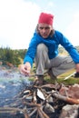 Hiking man try to light fire Royalty Free Stock Photo