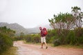 Hiking, man and walking outdoor for travel, backpack and nature for fresh air and fitness on trip. Trekking, mountain Royalty Free Stock Photo