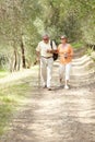 Hiking, nature and senior couple with walking stick, fitness and retirement exercise, wellness support or path in forest Royalty Free Stock Photo