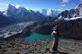 Hiking in Nepal Himalayas, Stone pyramid on Gorio Ri with view of Gokyo lake, Gokyo village, Ngozumba glacier and mountains Royalty Free Stock Photo