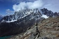 Hiking in Nepal Himalayas, Stone pyramid with view of Pharilapche mountain range Royalty Free Stock Photo