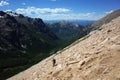 Hiking in Patagonia, Man with backpack walking steep loose rock mountainside Cerro Catedral mountain Royalty Free Stock Photo