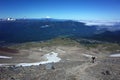 Hiking in Patagonia, Tourist walking up steep slope of volcano Puyehue, Puyehue National Park, Chile. Panoramic view Royalty Free Stock Photo