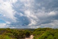 Hiking path in bushland with storm clouds in the sky Royalty Free Stock Photo