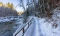 Hiking Path in Canadian Nature, Trees in Forest, Winter Snow, Sunny Sky, River Royalty Free Stock Photo