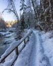 Hiking Path in Canadian Nature, Trees in Forest, Winter Snow, Sunny Sky, River. Royalty Free Stock Photo