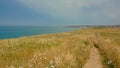 Hiking path in a filed on the ciffs on the French Northe sea coast Royalty Free Stock Photo