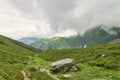 Hiking path among green alpine valley Royalty Free Stock Photo