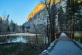 Hiking path leading to bridge over river in Yosemite with golden mountains Royalty Free Stock Photo