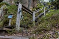 Hiking poles leaning on the handrail of a wooden stairs in a Finnish forest, Repovesi National Park Royalty Free Stock Photo