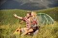 Hiking romance. Camping in mountains. Family travel. Summer vacation. Boyfriend girlfriend guitar near camping tent Royalty Free Stock Photo