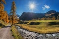 Hiking route through autumnal sertig valley with colorful larch