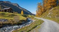 Hiking route through autumnal sertig valley with colorful larch