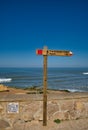 Hiking route wooden sign, pointing to Praia do Magoito. Sintra, Portugal.