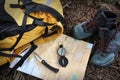 Hiking shoes on map with compass Royalty Free Stock Photo