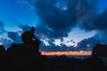 Hiking silhouette backpacker, man looking at ocean