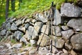 hiking stick leaning on a stone wall