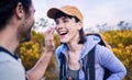 Hiking, sunscreen and happy couple on mountain for adventure, holiday and journey in nature. Travel, dating and man and