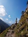 Hiking in Tatra National Park, Poland, in May. Beautiful panoramic view on rocky mountains. A hiker standing on the top looking Royalty Free Stock Photo