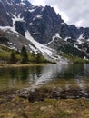 Hiking in Tatra National Park, Poland, in May. Beautiful panoramic view on rocky and snowy mountains, and famous mountains lake Royalty Free Stock Photo