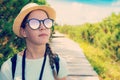 Hiking teenage tourist girl in sunglasses in the mountains Royalty Free Stock Photo