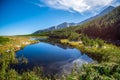 Hiking to mountain lake in National Park High Tatra in autumn and sunny day. Dramatic overcast sky. Zelene pleso, Slovakia, Europe Royalty Free Stock Photo