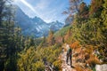 Hiking to mountain lake in National Park High Tatra in autumn and sunny day. Dramatic overcast sky. Zelene pleso, Slovakia Royalty Free Stock Photo