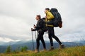 Hiking together. Woman and man. Majestic Carpathian Mountains. Beautiful landscape of untouched nature Royalty Free Stock Photo