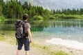 Hiking tourist and lake near Alps in Almsee in Austria