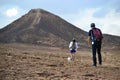 Hiking towards mountain at bottom of Makhtesh Ramon Crater, Mitzpe Ramon, Negev desert, Israel