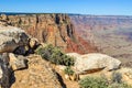 A Hiking Trail Along the North Rim of the Grand Canyon in Arizona is Guarded by Large Boulders and Sagebrush Royalty Free Stock Photo