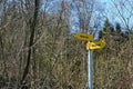 Hiking trail arrow shaped signposts in German language showing in two different directions.