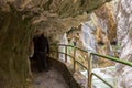 Hiking trail Cares Trail or Ruta del Cares in the narrow tunnel along river Cares in cloudy spring day near Cain, Picos de Europa Royalty Free Stock Photo