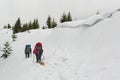 Hiking trail in a deep snow high in the winter mountains