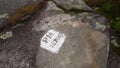 Hiking trail distance marker on large stone