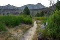 Hiking trail through field of grass in smith rock national park with cliffs in background during sunrise Royalty Free Stock Photo