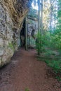 Hiking trail in forest with sandstone rock massif in CHKO Kokorinsko - Machuv kraj in Czech republic