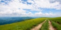 Hiking trail through grassy hills Royalty Free Stock Photo