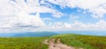 Hiking trail through grassy hills Royalty Free Stock Photo