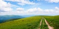 Hiking trail through grassy hills Royalty Free Stock Photo