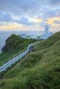 Hiking trail leading to a lighthouse on the cliff in northern coast of Taiwan at sunrise Royalty Free Stock Photo