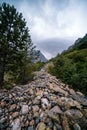 Hiking trail to Chalaadi Glacier in Mestia, Georgia. Summer rainy day. A mound of large boulders, stones that fell from the