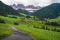 Hiking trail to St Magdalena church in Val di Funes valley, Dolomites, Italy. Furchetta and Sass Rigais mountain peaks Royalty Free Stock Photo