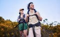 Hiking, travel and couple walking in nature for adventure, holiday and sightseeing journey on mountain. Fitness, dating