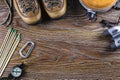 Hiking or travel equipment with boots, compass, binoculars, matches on wooden background. Active lifestyle concept. Royalty Free Stock Photo