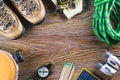 Hiking or travel equipment with boots, compass, binoculars, matches on wooden background. Active lifestyle concept Royalty Free Stock Photo