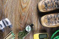 Hiking or travel equipment with boots, compass, binoculars, matches on wooden background. Active lifestyle concept Royalty Free Stock Photo