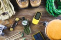 Hiking or travel equipment with boots, compass, binoculars, matches on wooden background. Active lifestyle concept Royalty Free Stock Photo